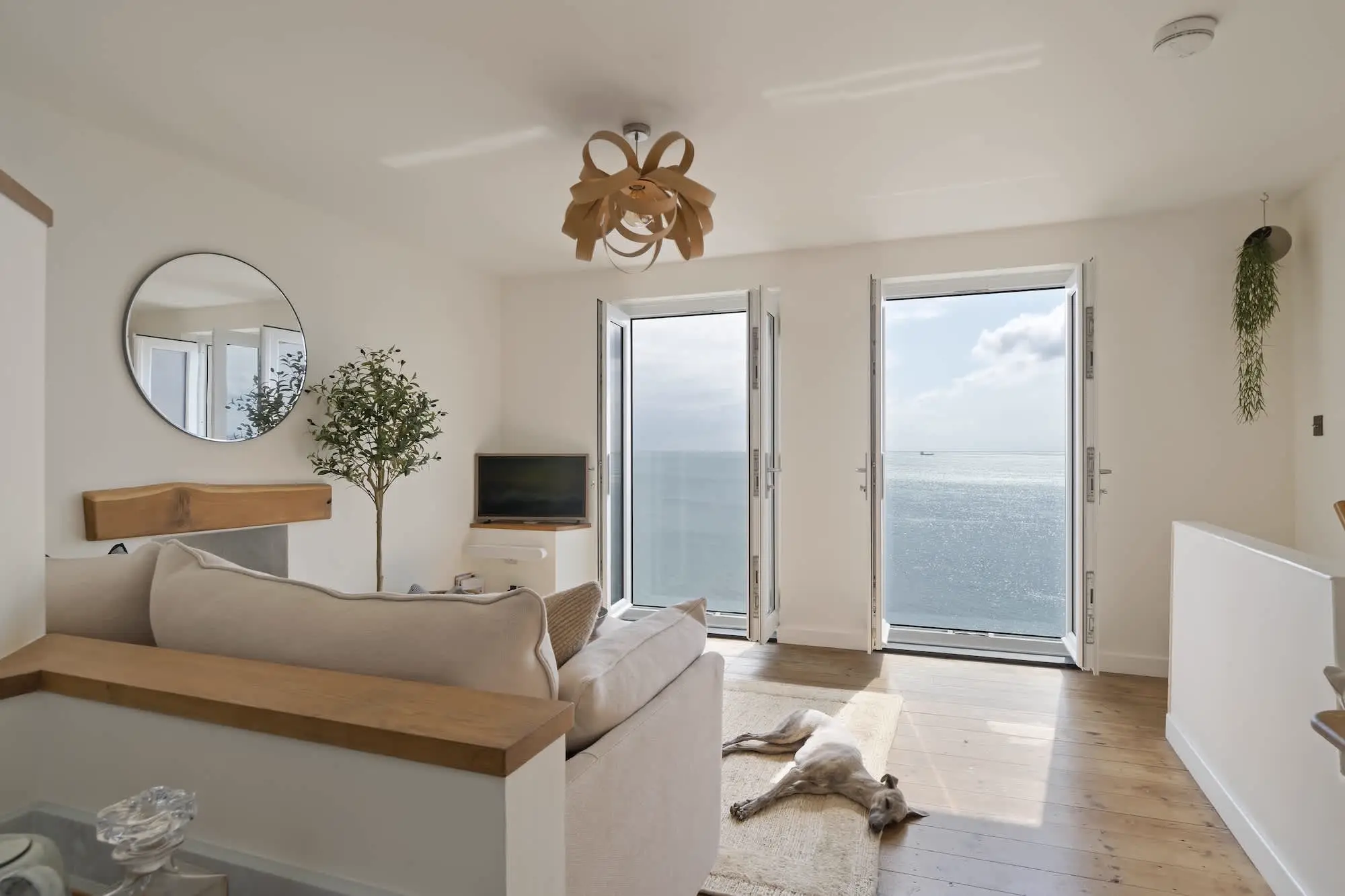 Living room windows at Triton framing the full sweep of Mount's Bay towards the Lizard